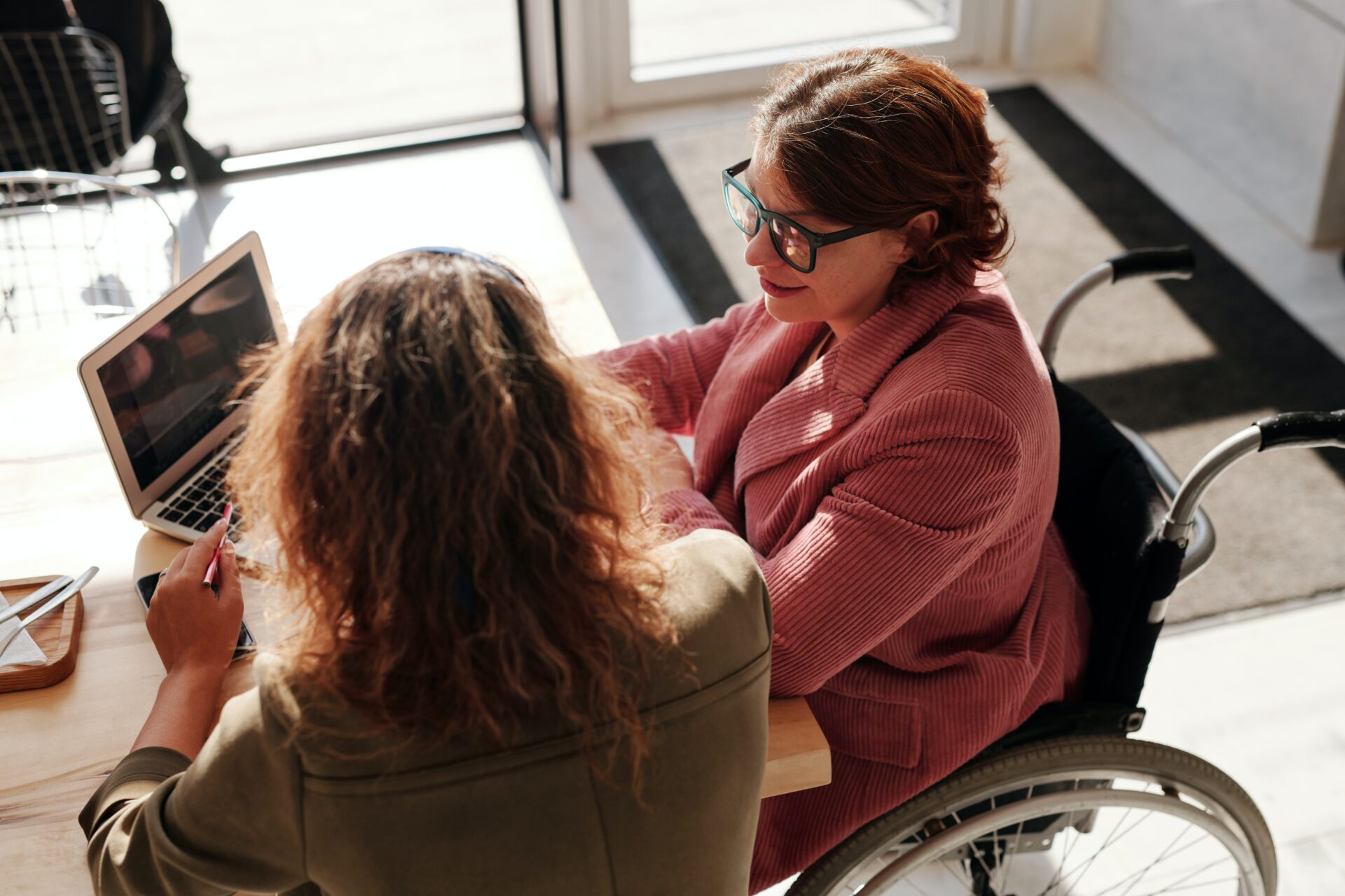 Two women working at a laptop
