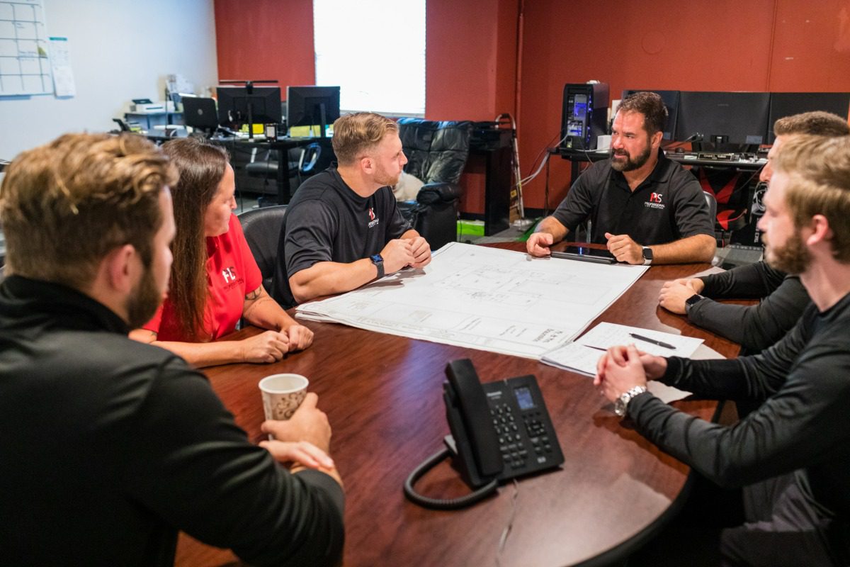 Team discussing plans around conference table
