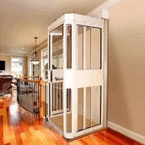 Residential elevator beside wooden railing