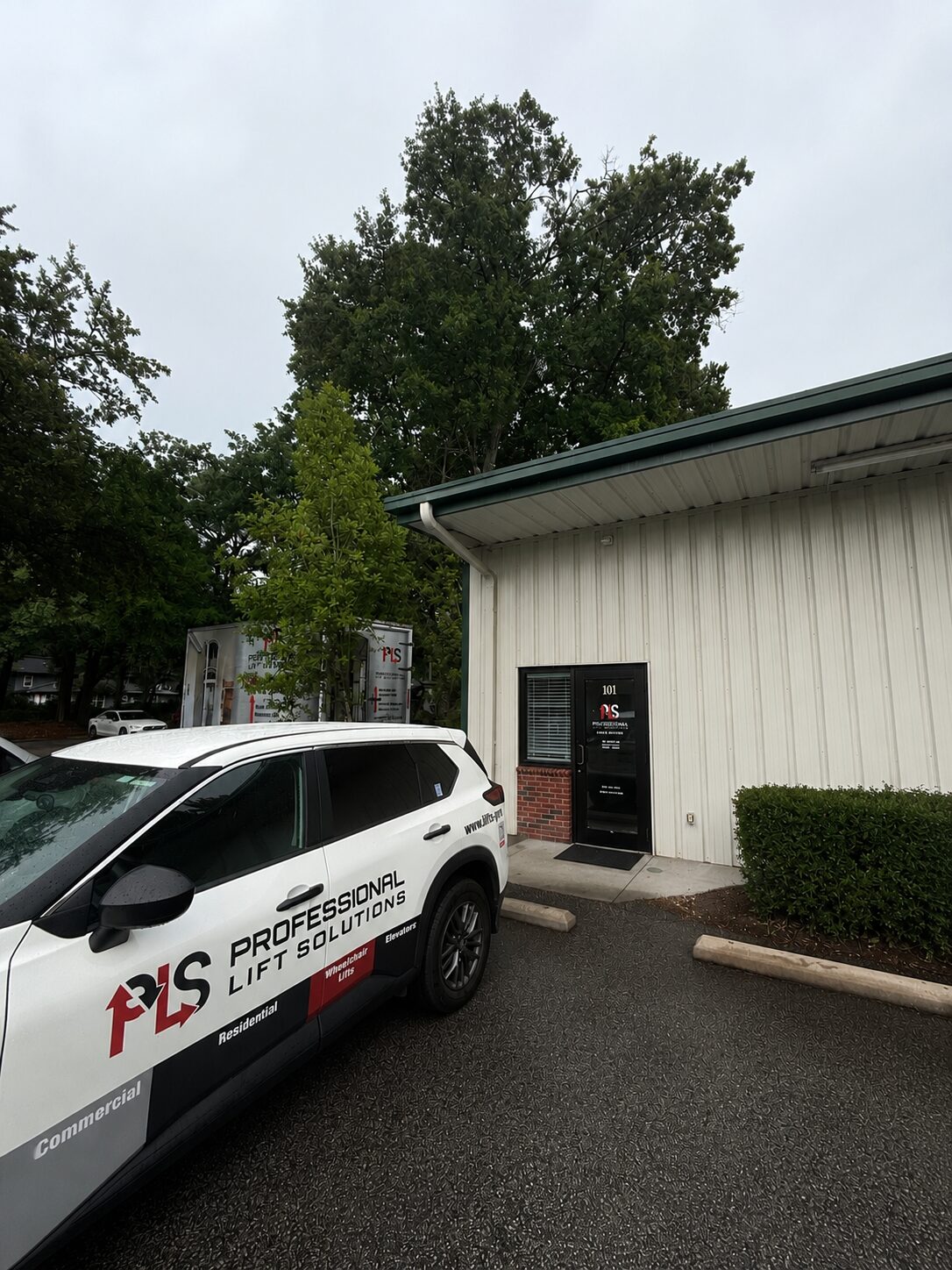 PLS vehicle parked by industrial building