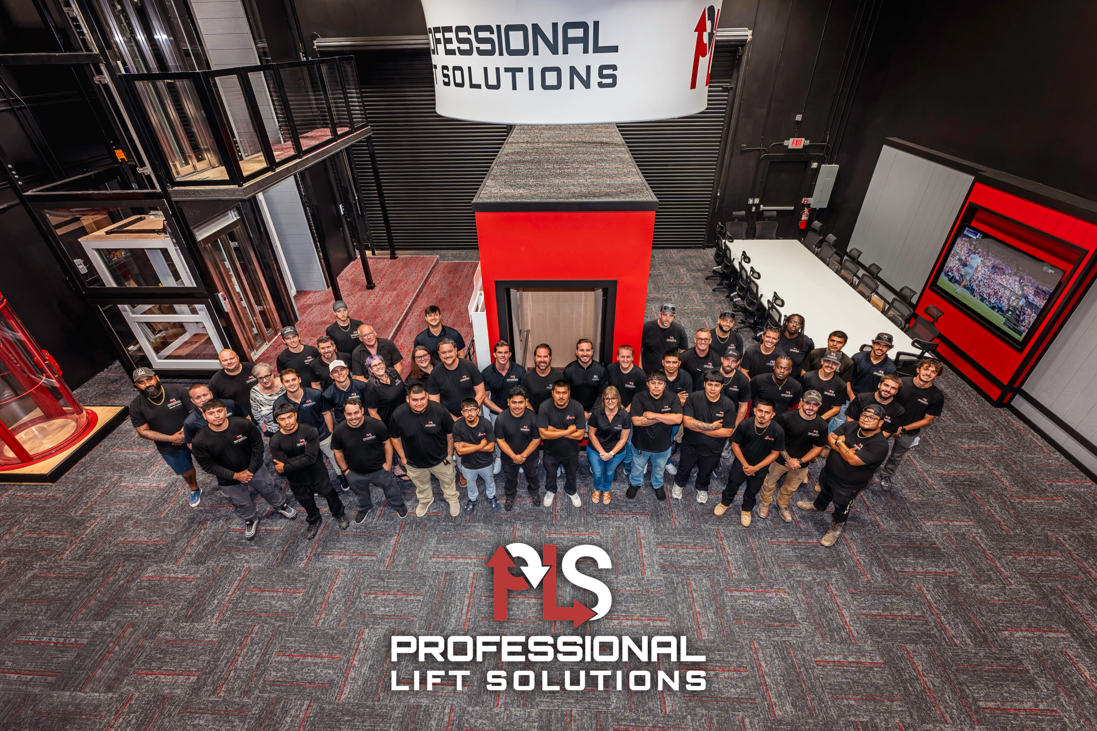 Professional Lift Solutions team in facility